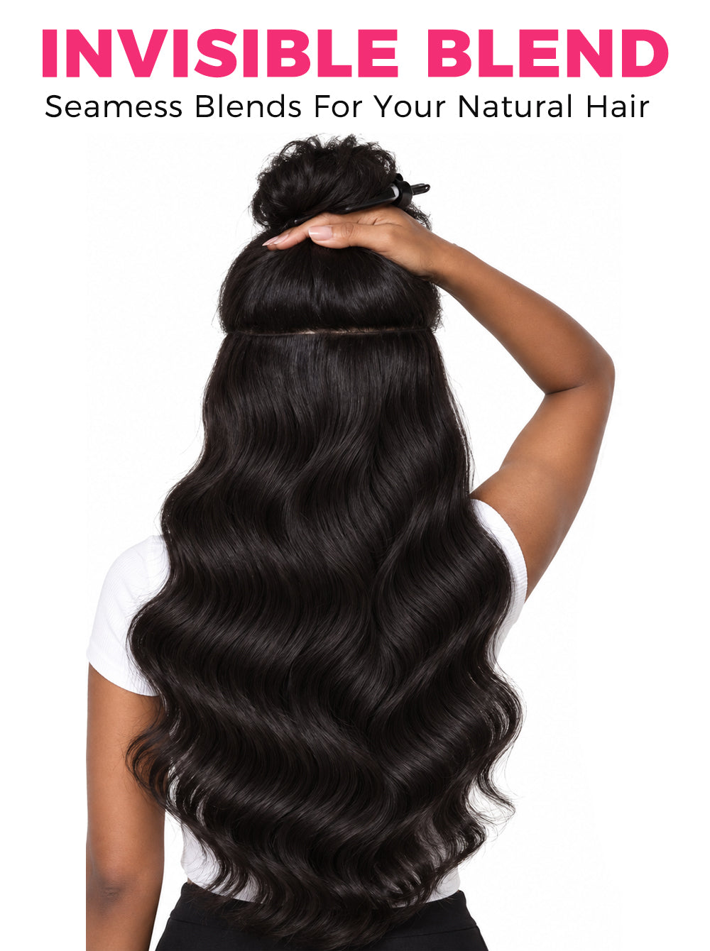 A model shown from the back with long, dark brown to black body wavy hair extensions blended seamlessly into her natural hair. The top of her hair is pulled up, showing the blend line.